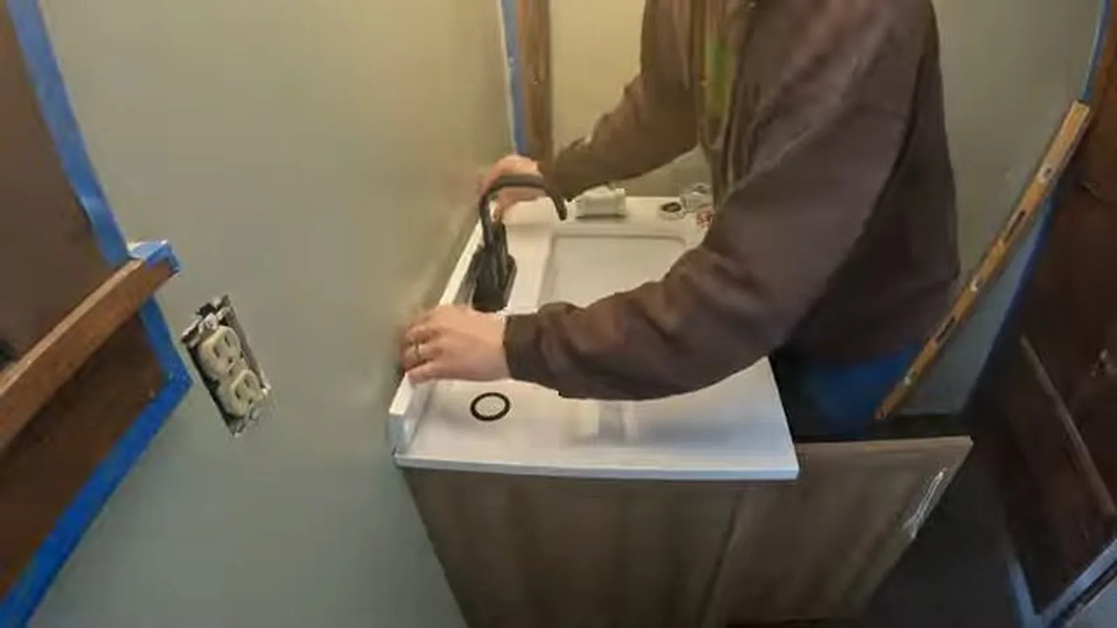 Tile work underway around a reset toilet flange during a service visit in Avalon