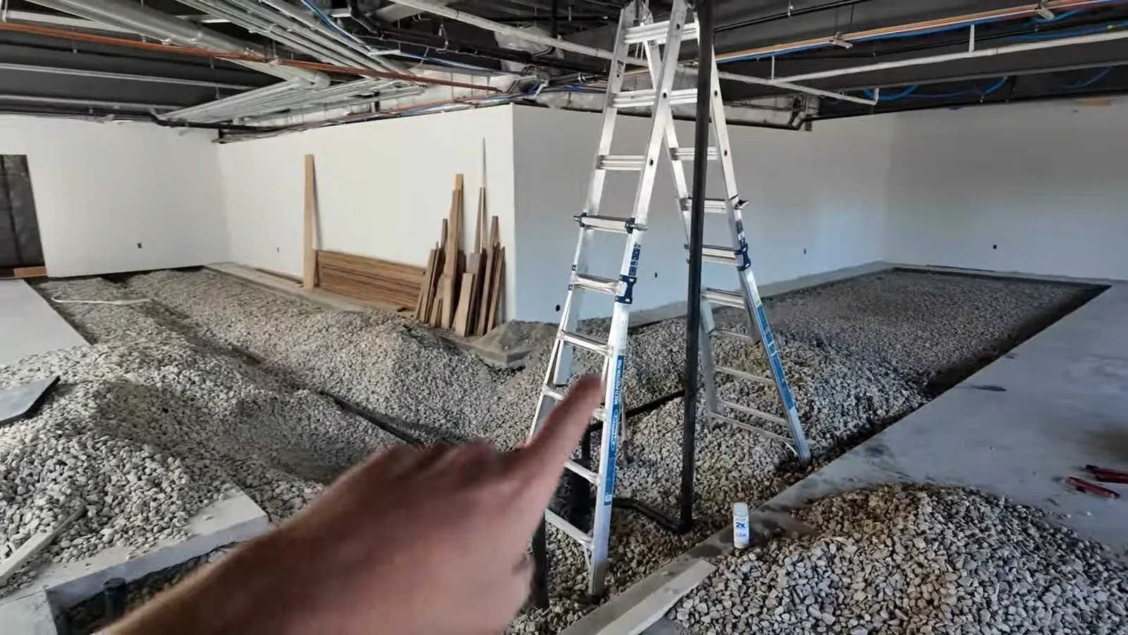 A technician laying out drain lines before a commercial floor pour during Commercial Plumbing service in Alpharetta