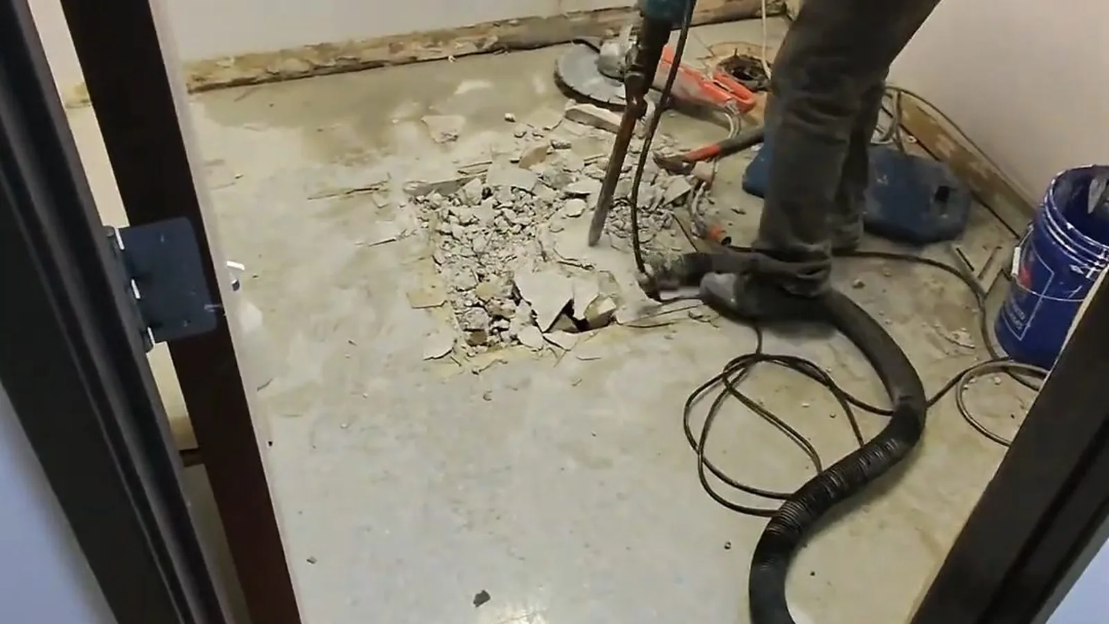 A technician laying out drain lines before a commercial floor pour, representing plumbing service in Buford, GA