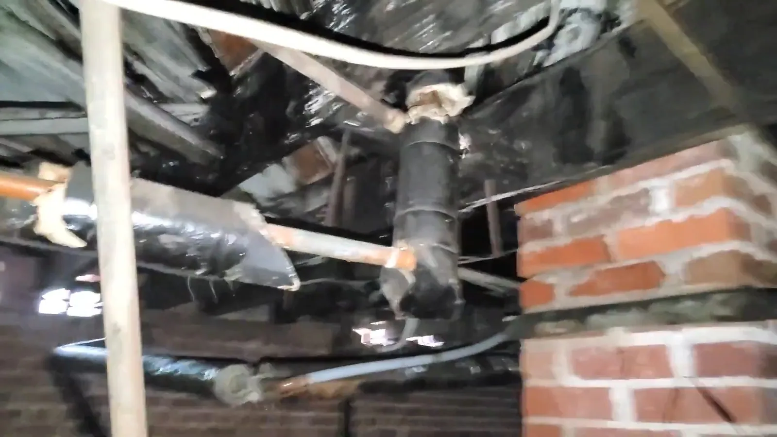 Insulation and ductwork sharing a crawl space with the plumbing on a plumbing call in Downtown Alpharetta