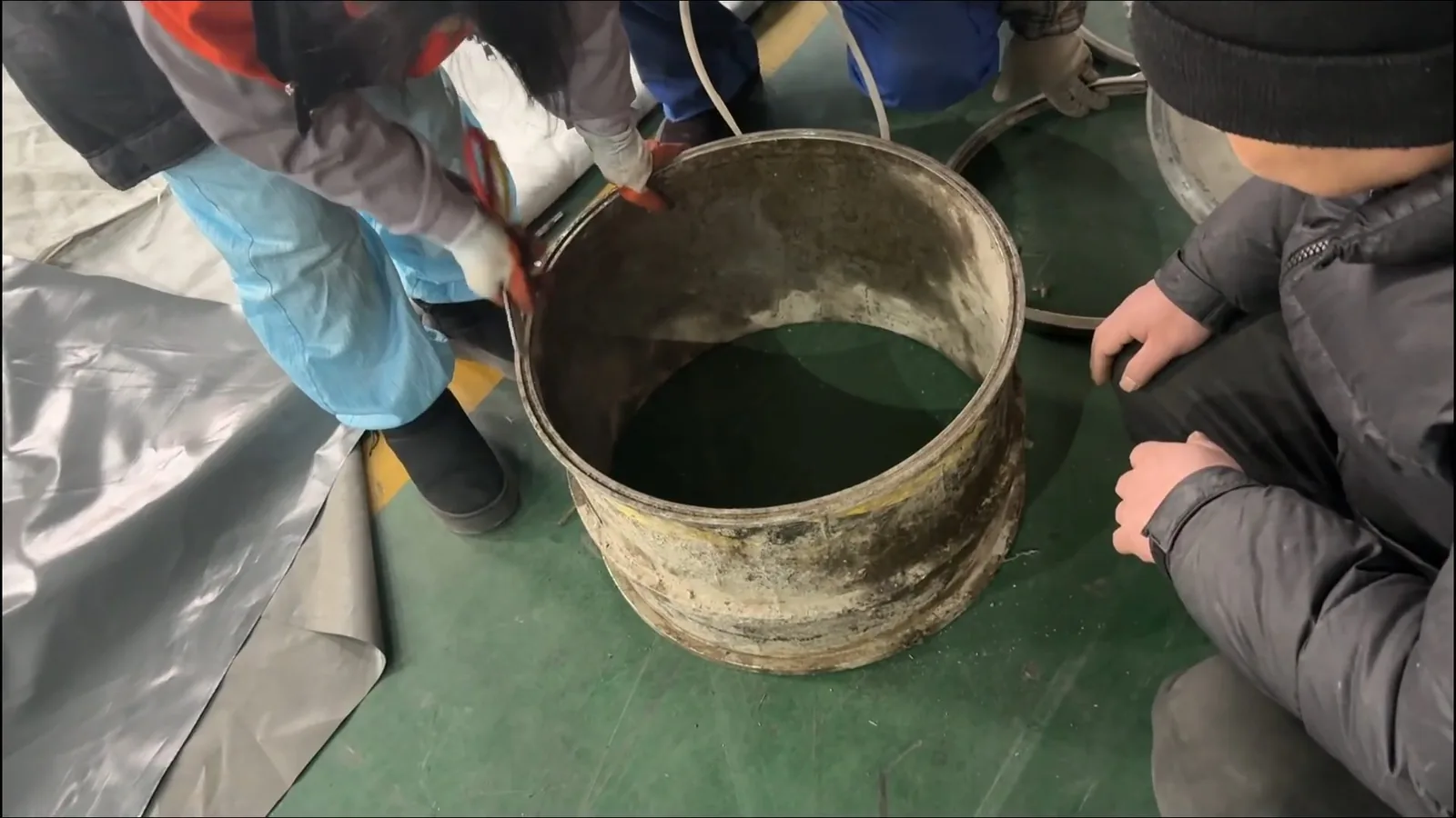 A kitchen drain being cleared with a cable machine, related to Drain Cleaning & Unclogging questions homeowners ask