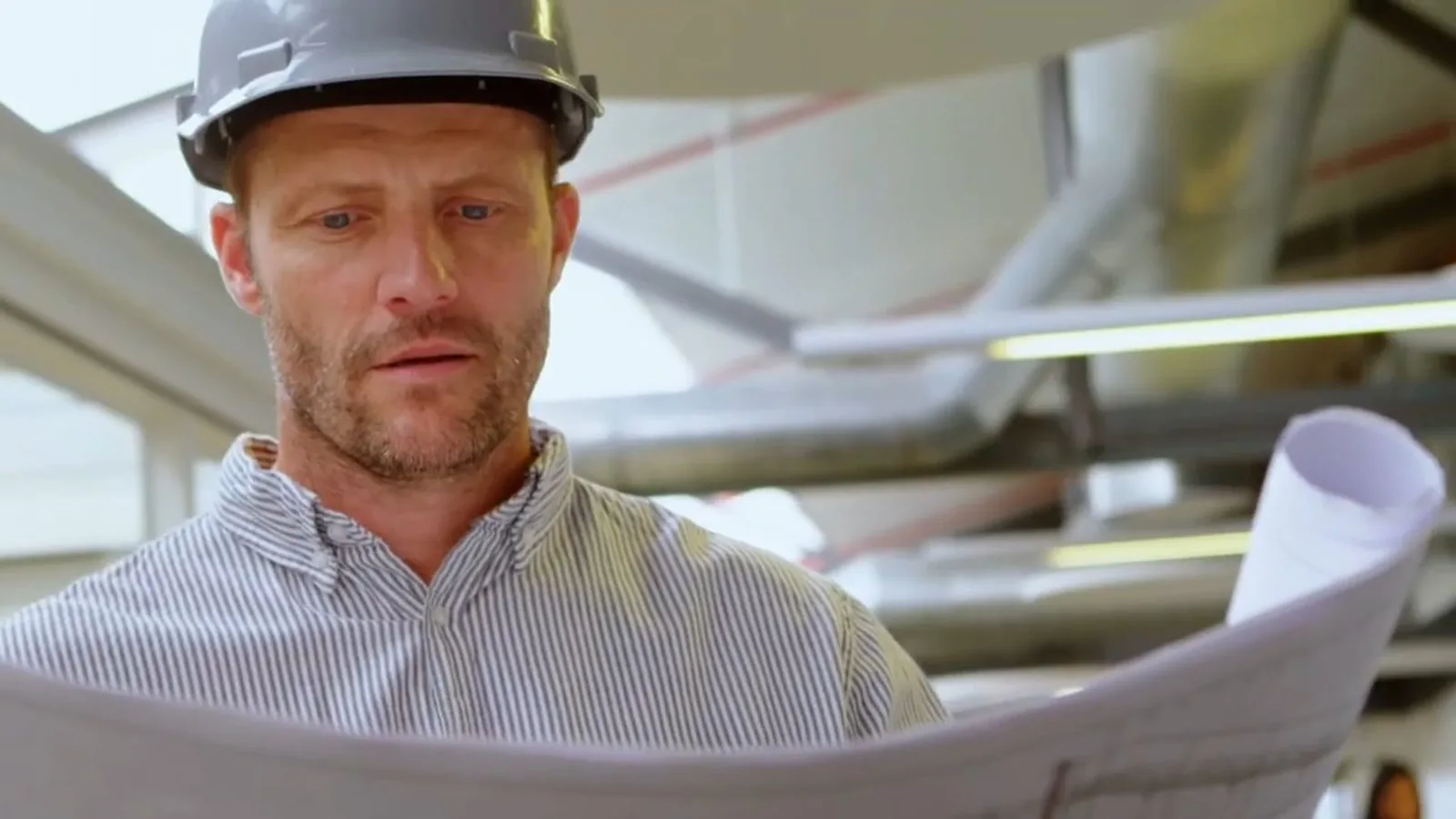 A plumber reviewing a job's paperwork on site representing Alpharetta Plumbing Pros' work
