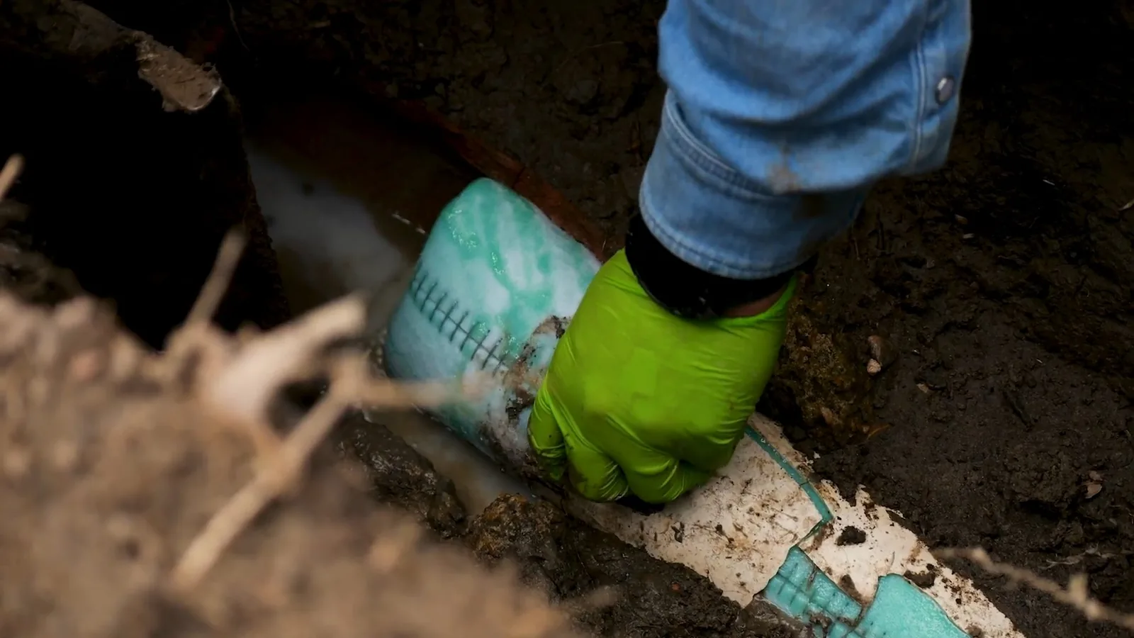 A failed section of cast iron pipe cut out of the ground, representing plumbing service in Norcross, GA