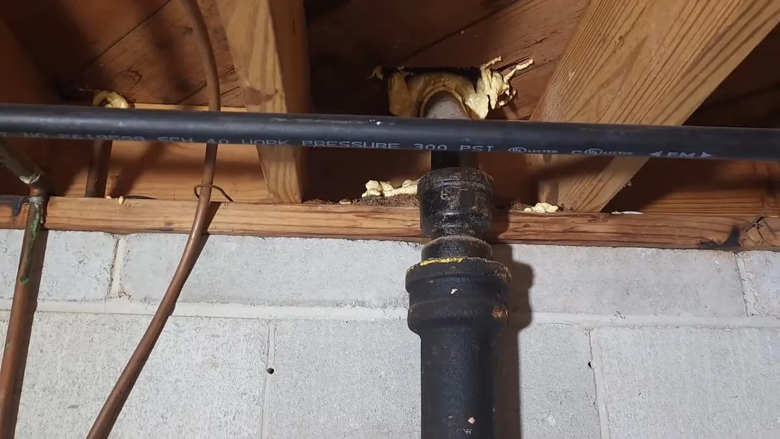 A failed section of cast iron pipe cut out of the ground, representing plumbing service in Milton, GA