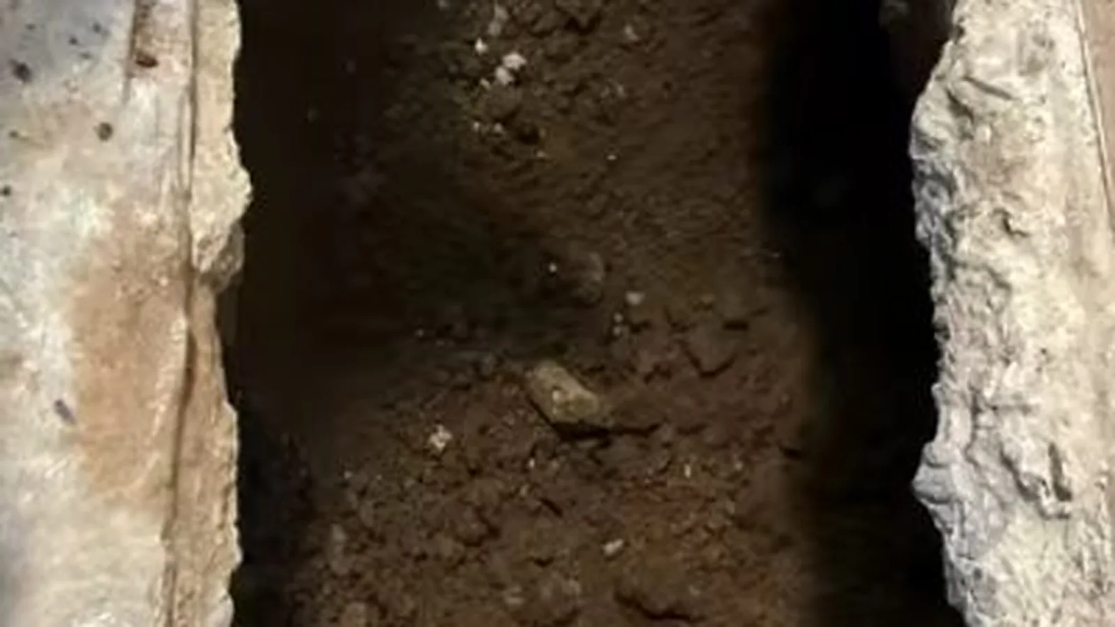 A technician backfilling a sewer line repair trench, related to Sewer Line Repair questions homeowners ask
