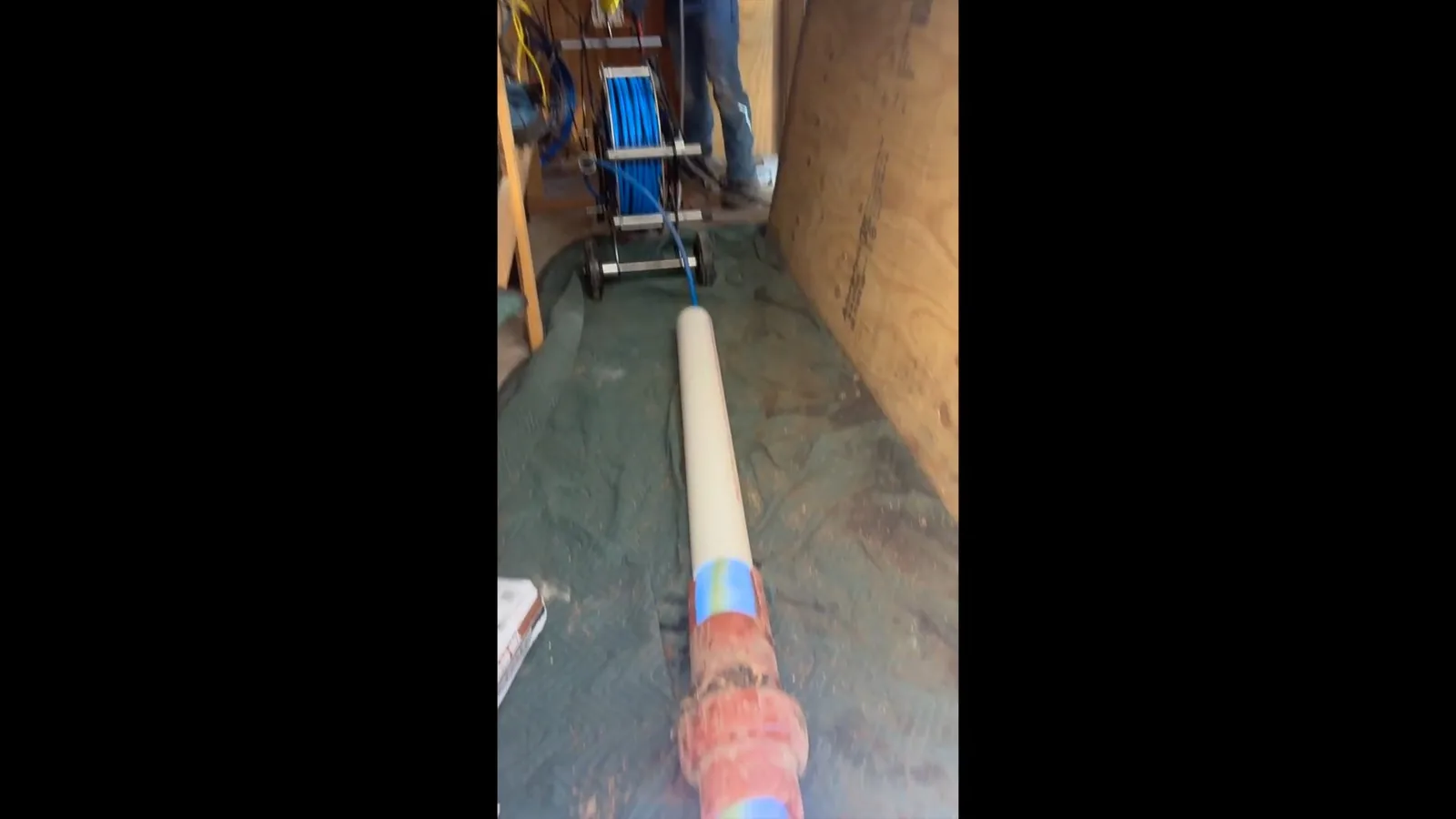 A technician monitoring a trenchless repair from the access point, representing plumbing service in Halcyon