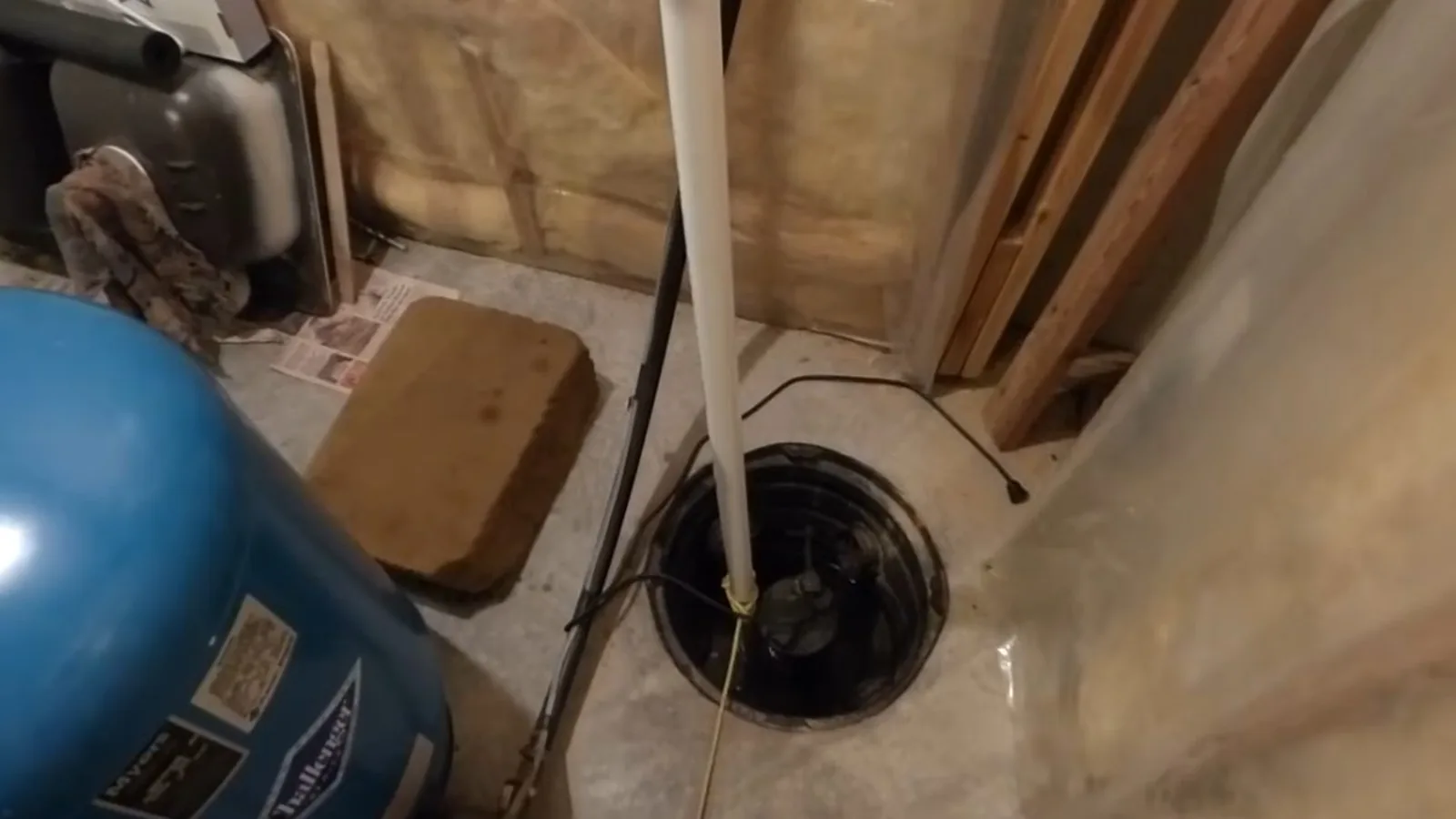 A sump pump being tested with water poured into the basin during Sump Pump Installation & Repair service in Alpharetta