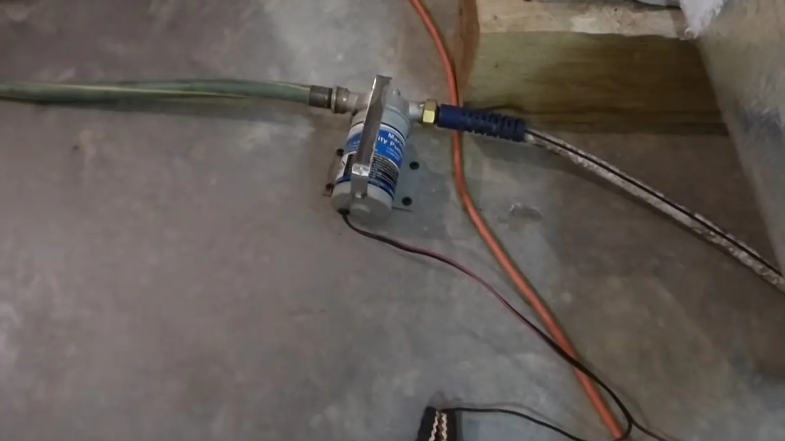 A sump pump discharge line routed out of a basement during Sump Pump Installation & Repair service in Alpharetta