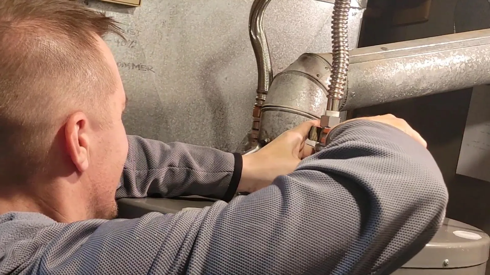 An old water heater disconnected before replacement, related to Water Heater Installation & Replacement questions homeowners ask