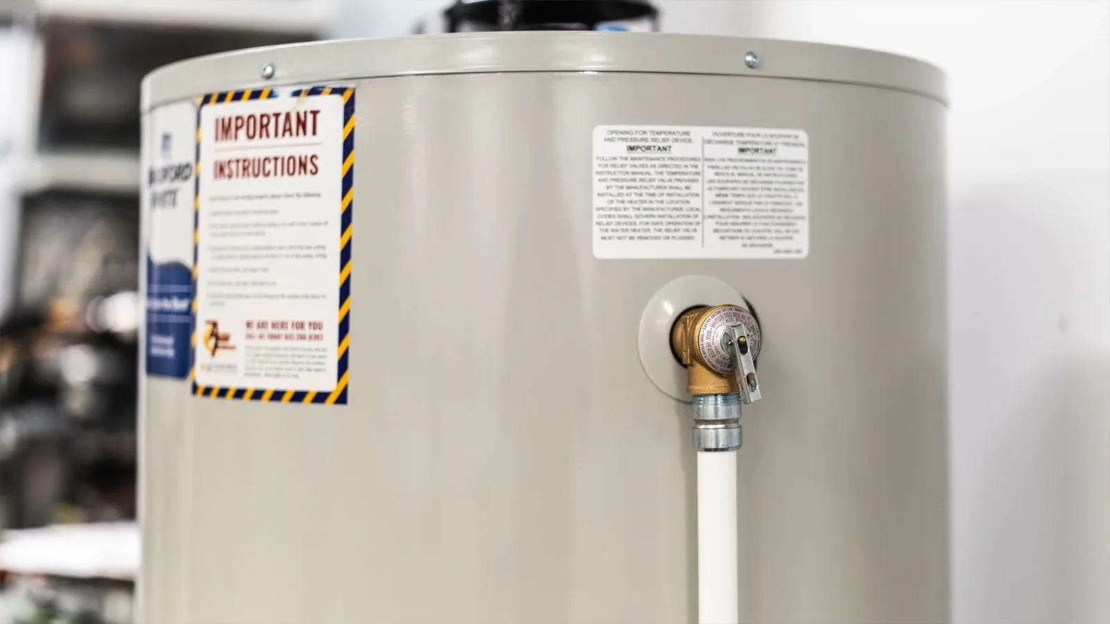 A technician inspecting a water heater's burner assembly, representing plumbing service in Webb Bridge