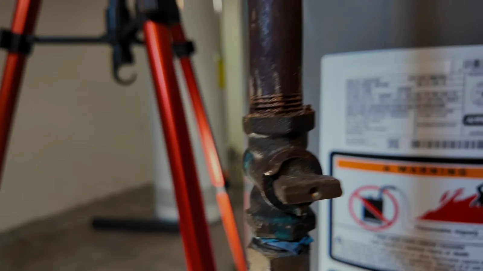 A technician securing a new water heater's gas line during a service visit in Sugar Hill, GA
