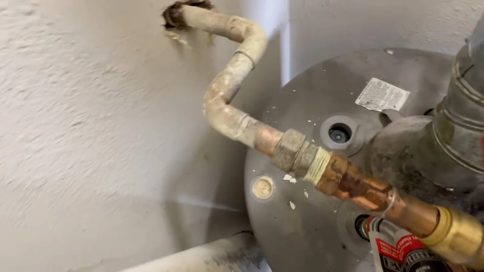 A water heater's anode rod removed for inspection on a plumbing call in Webb Bridge
