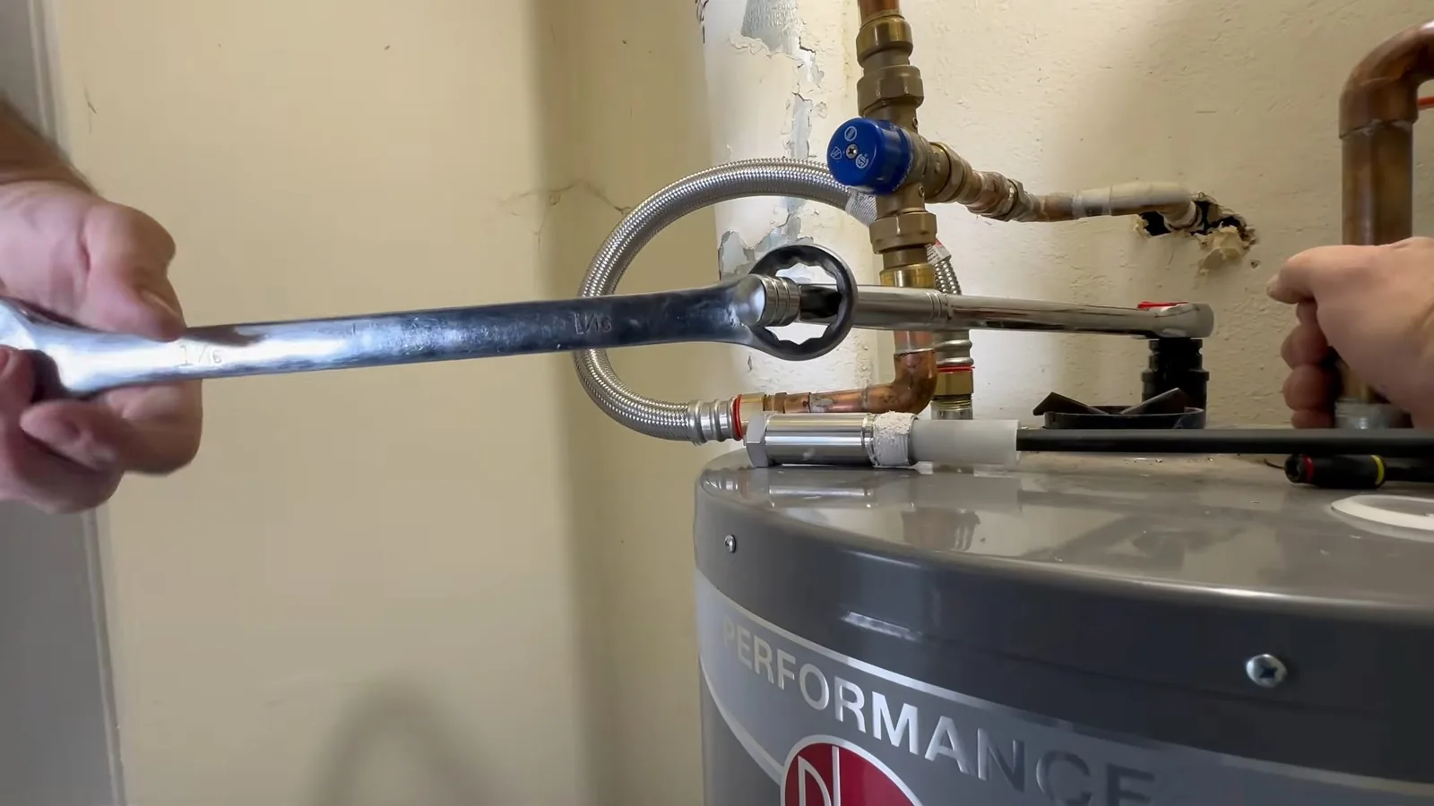 A water heater's pressure relief valve being tested during a service visit in Webb Bridge