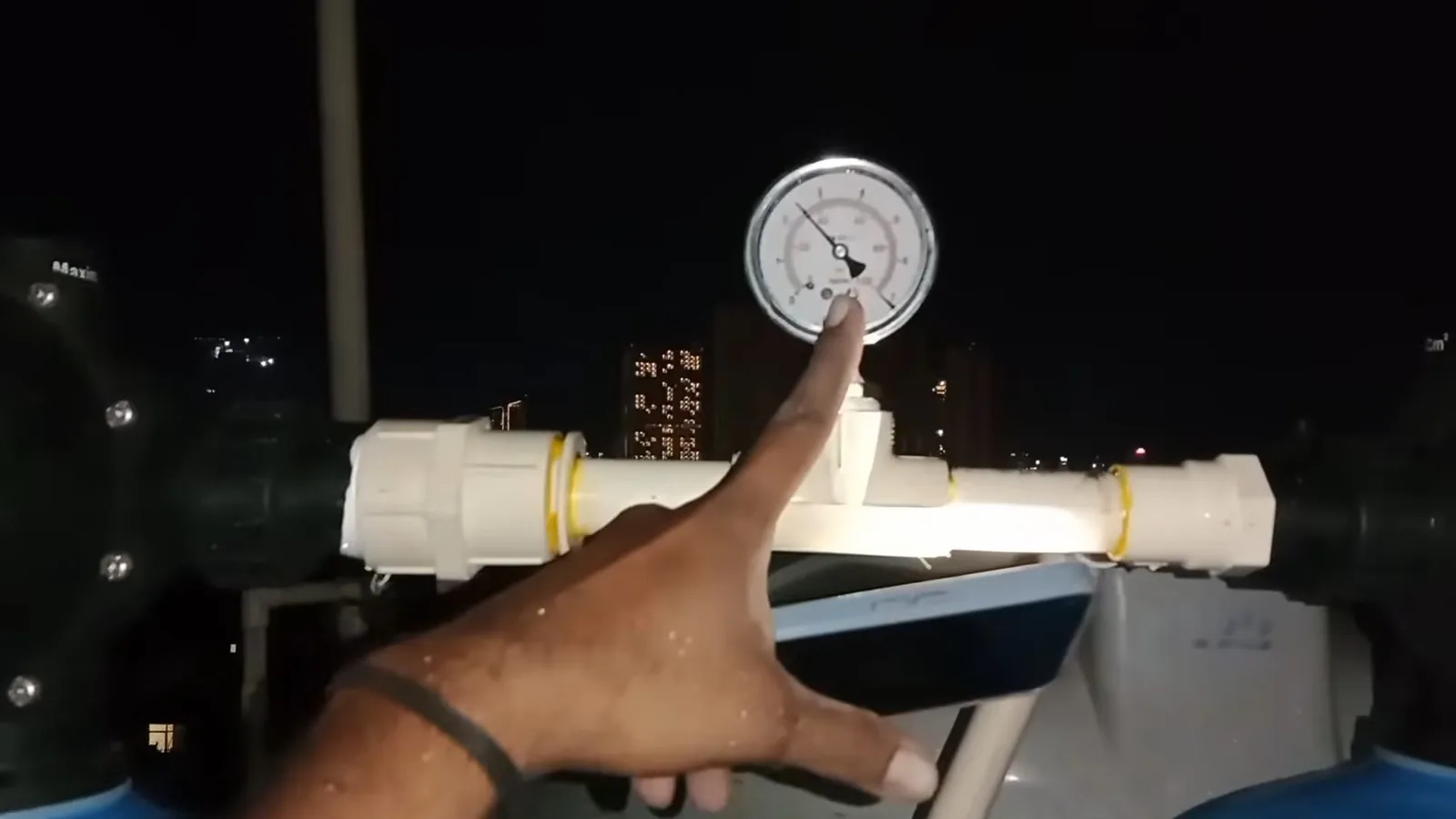 A water softener's brine tank being filled with salt, representing plumbing service in Windward
